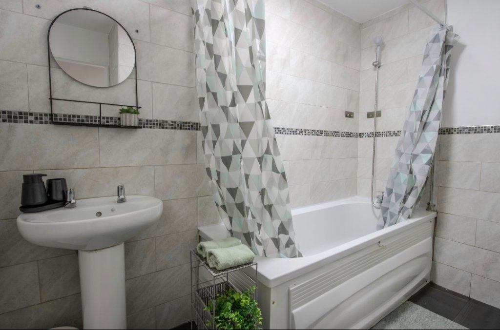 Bathroom with bath and shower