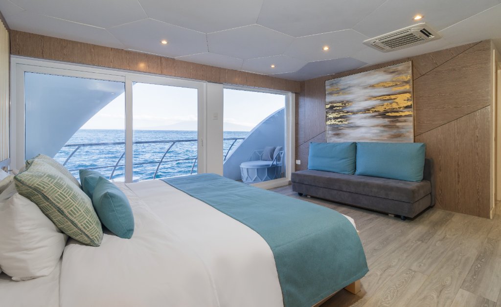 M/C Elite suite with sofa and ocean-facing windows