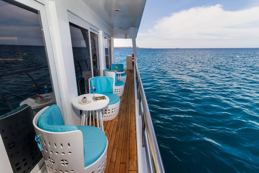 Main lounge aboard M/C Elite with ocean-facing windows