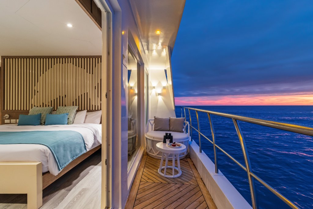 M/C Elite upper suite opening to a private balcony at sunset