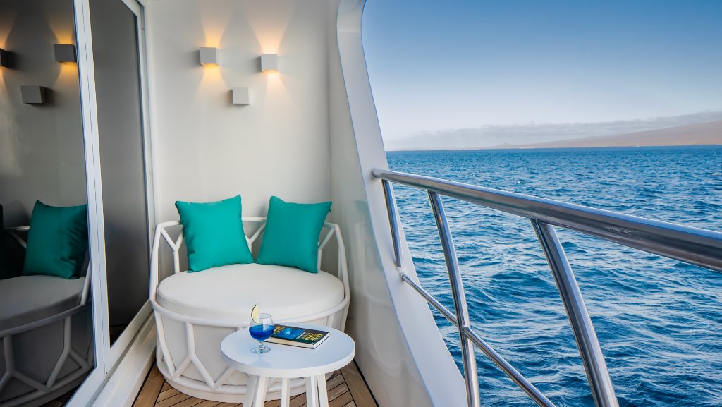 Private balcony seating from an M/C Elite suite overlooking Galapagos waters