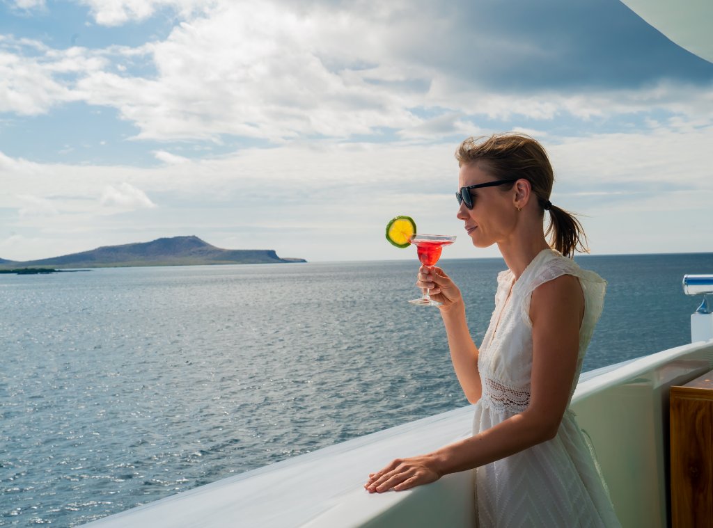 Bartender presenting signature cocktails aboard M/C Ocean Spray