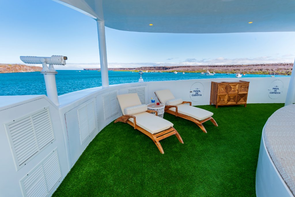 M/C Ocean Spray sky deck lounge with sofas and TVs