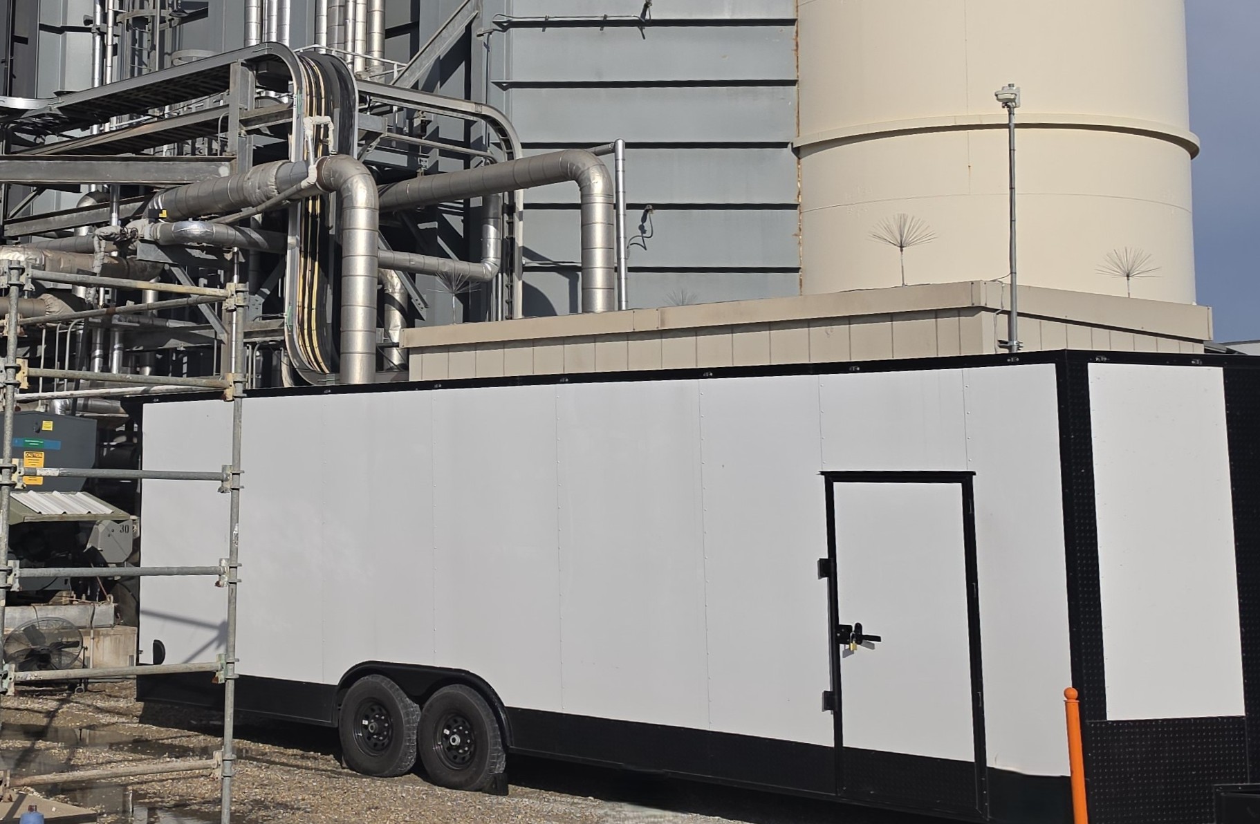 Industrial site trailer and storage tanks