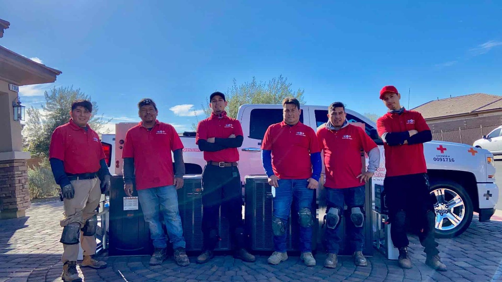A/C Medic Vegas LLC professional installation team with service truck (NV #0091716) and new high-efficiency HVAC units for a residential replacement in Las Vegas.