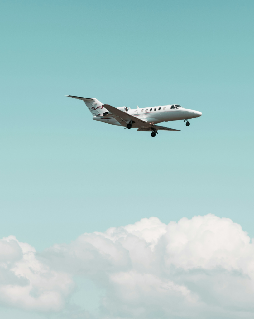 Private jet flying over coastline
