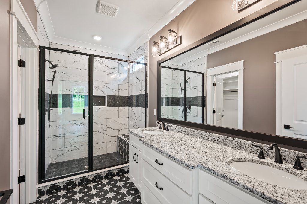 Primary bathroom with double vanity and walk-in shower