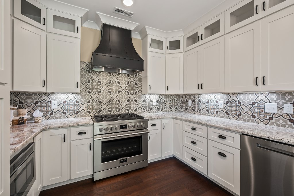 Kitchen cabinetry and custom backsplash