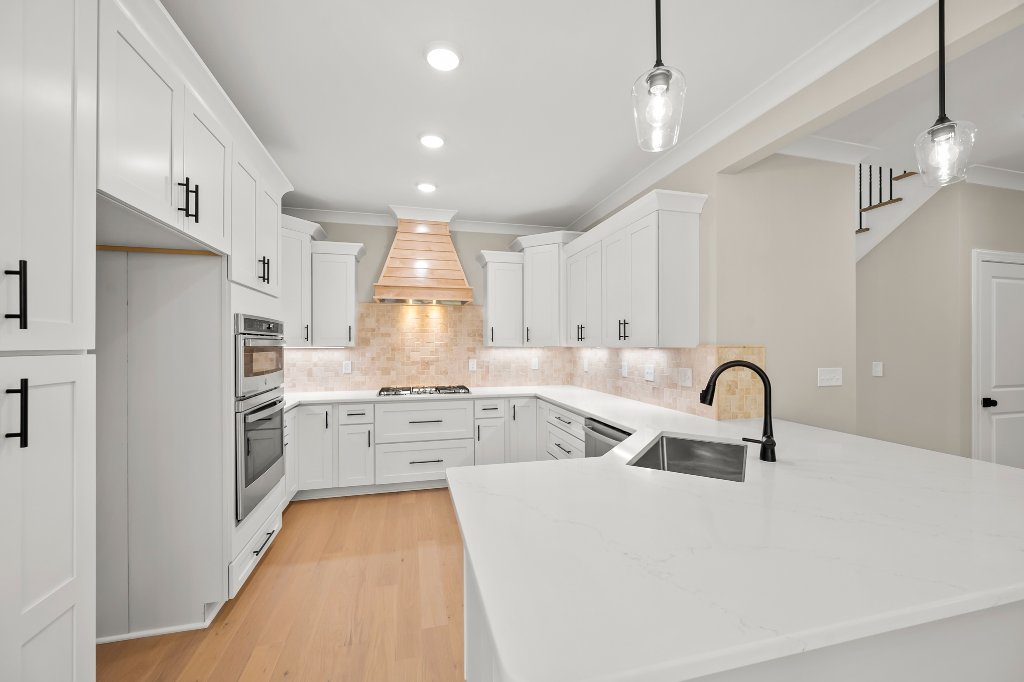 Kitchen with white cabinets and quartz counters
