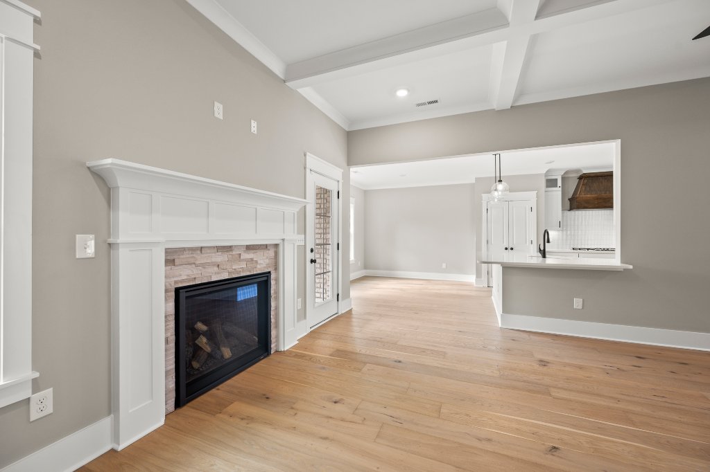 740 Surrey Path Trail, fireplace detail with kitchen view
