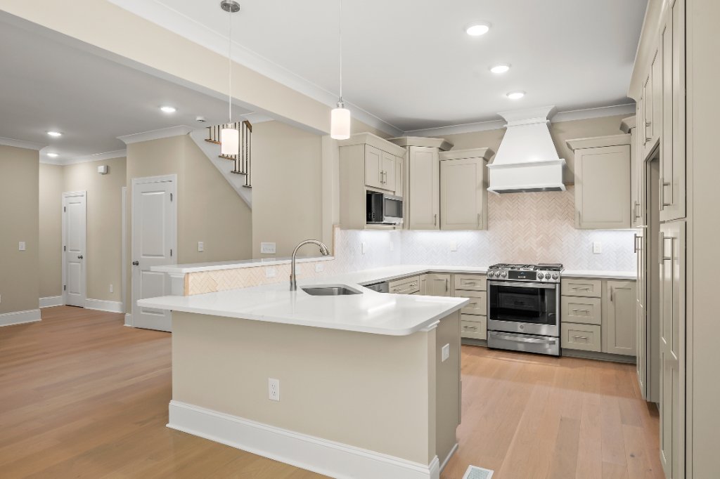 Kitchen with island and custom hood