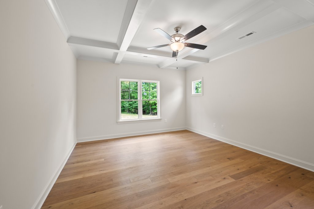 Primary bedroom with coffered ceiling