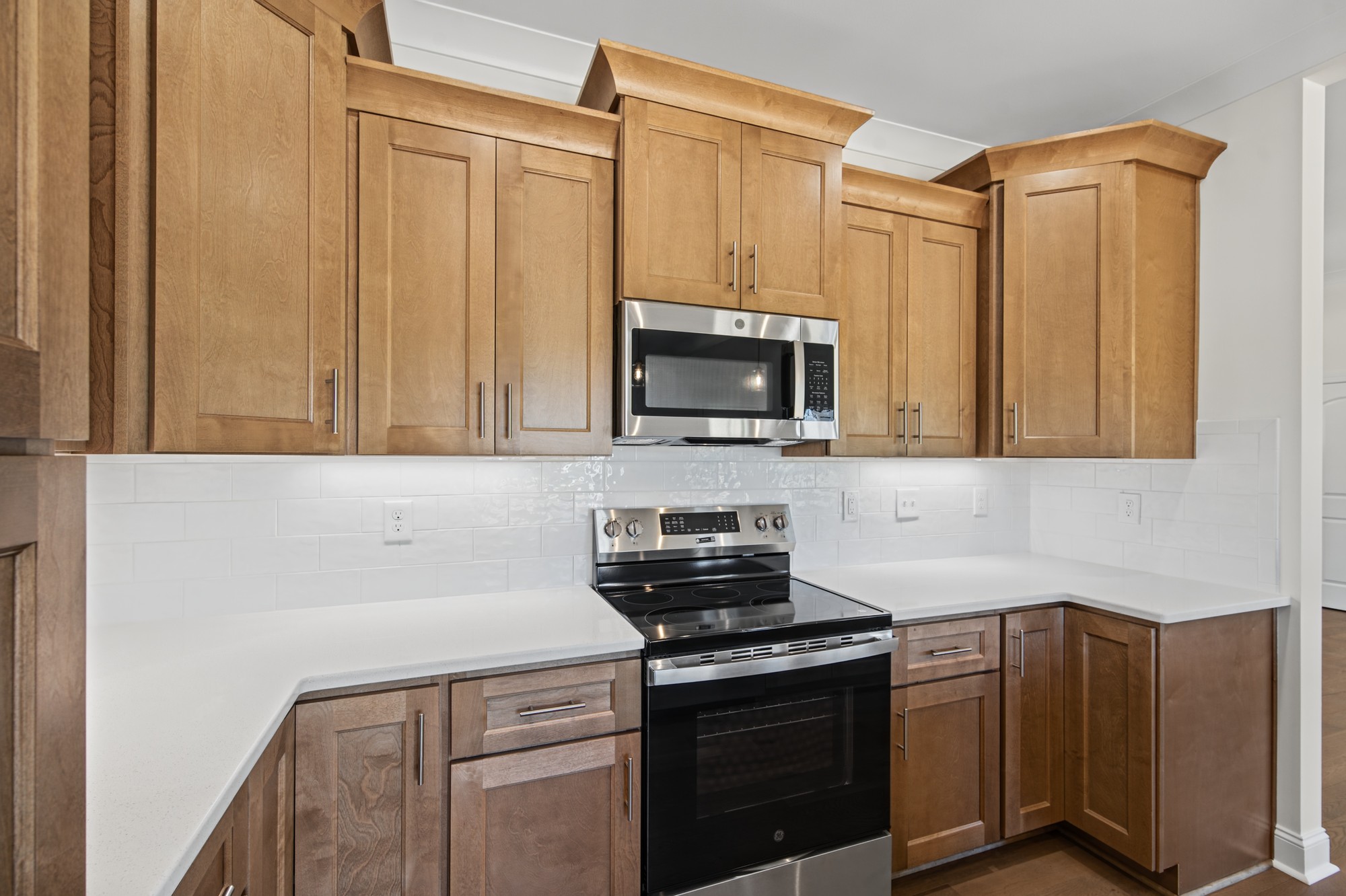 250 Cool Run - Kitchen Cabinetry with GE Range & Subway Tile Backsplash