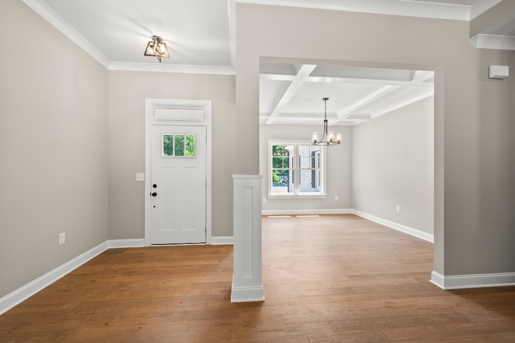 Foyer and dining room with coffered ceiling