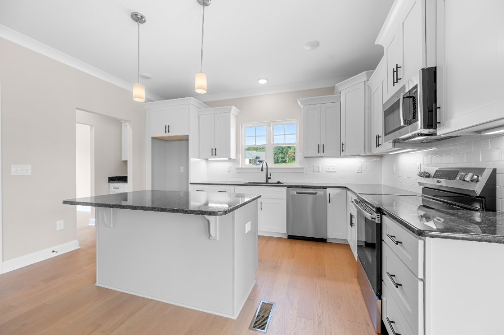 Kitchen with island and granite countertops