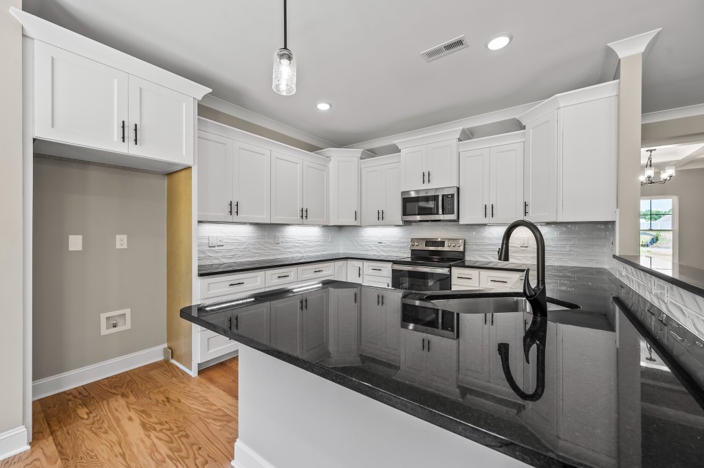 132 Cricket's Run, kitchen with white cabinets and granite countertops