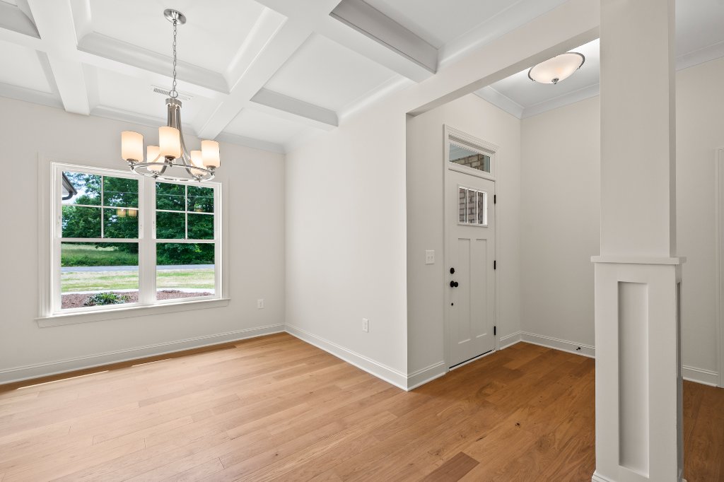 Foyer and dining room with coffered ceiling