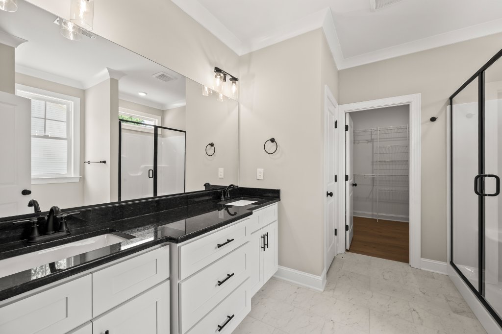 Primary bathroom with double vanity and walk-in shower