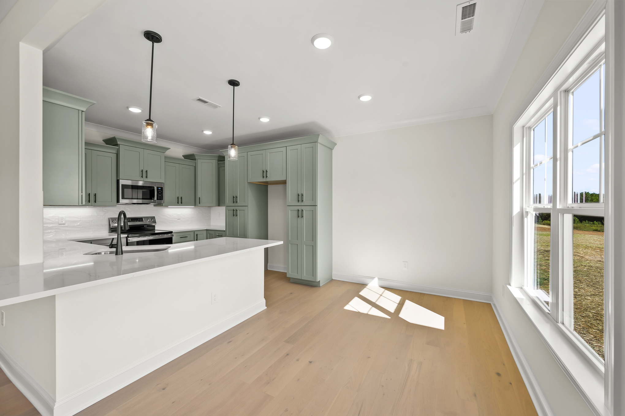 192 Cool Run - Kitchen with Sage Green Cabinetry & Peninsula