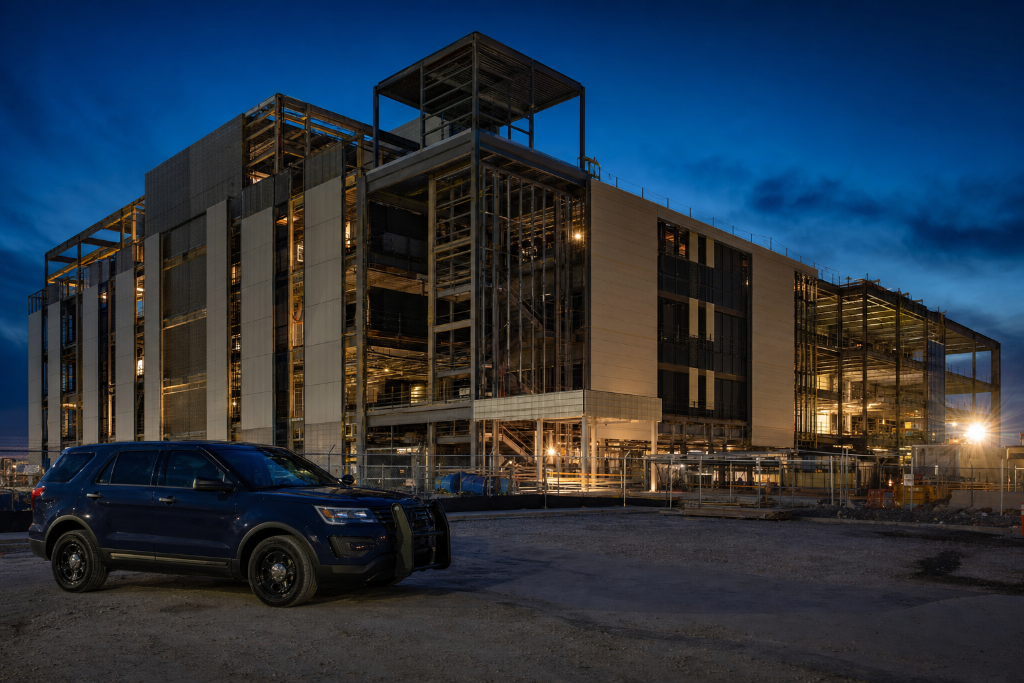 Commercial site material storage at night, copper and materials visible
