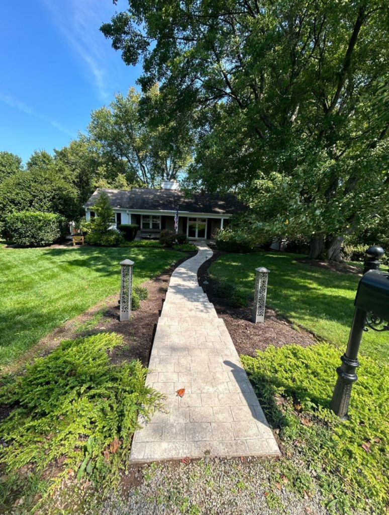Stone walkway and landscaping completed by Max's team