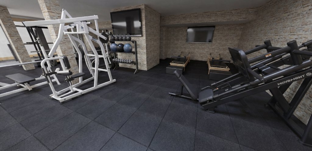 Wide-angle view of the Preston Hollow basement gym showing full equipment layout and stone feature walls