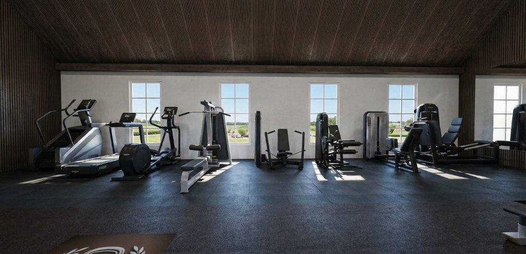 Free weight area of Highland Park gym with dual dumbbell racks, leather benches and cable functional trainer