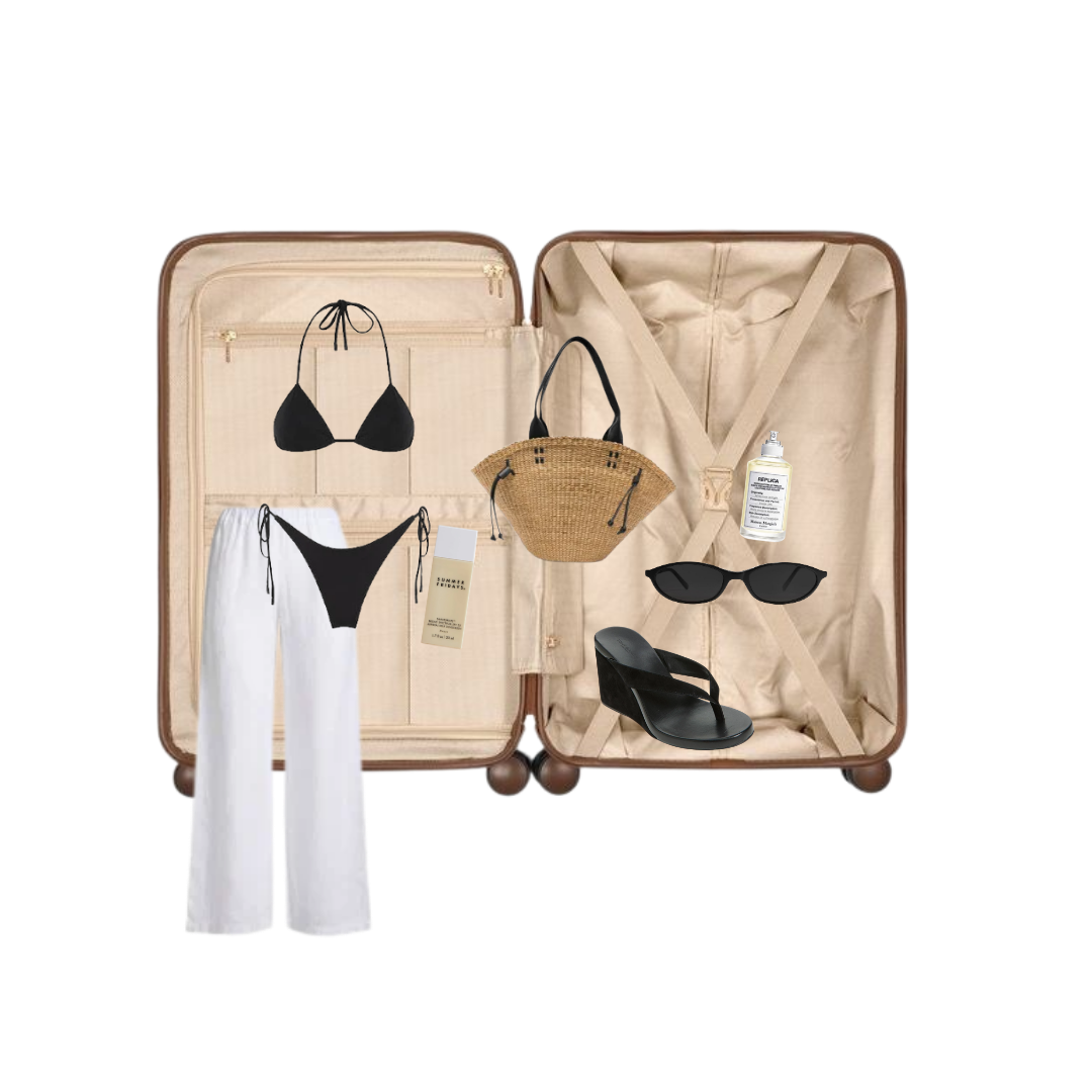 Open suitcase flat-lay with travel essentials on black