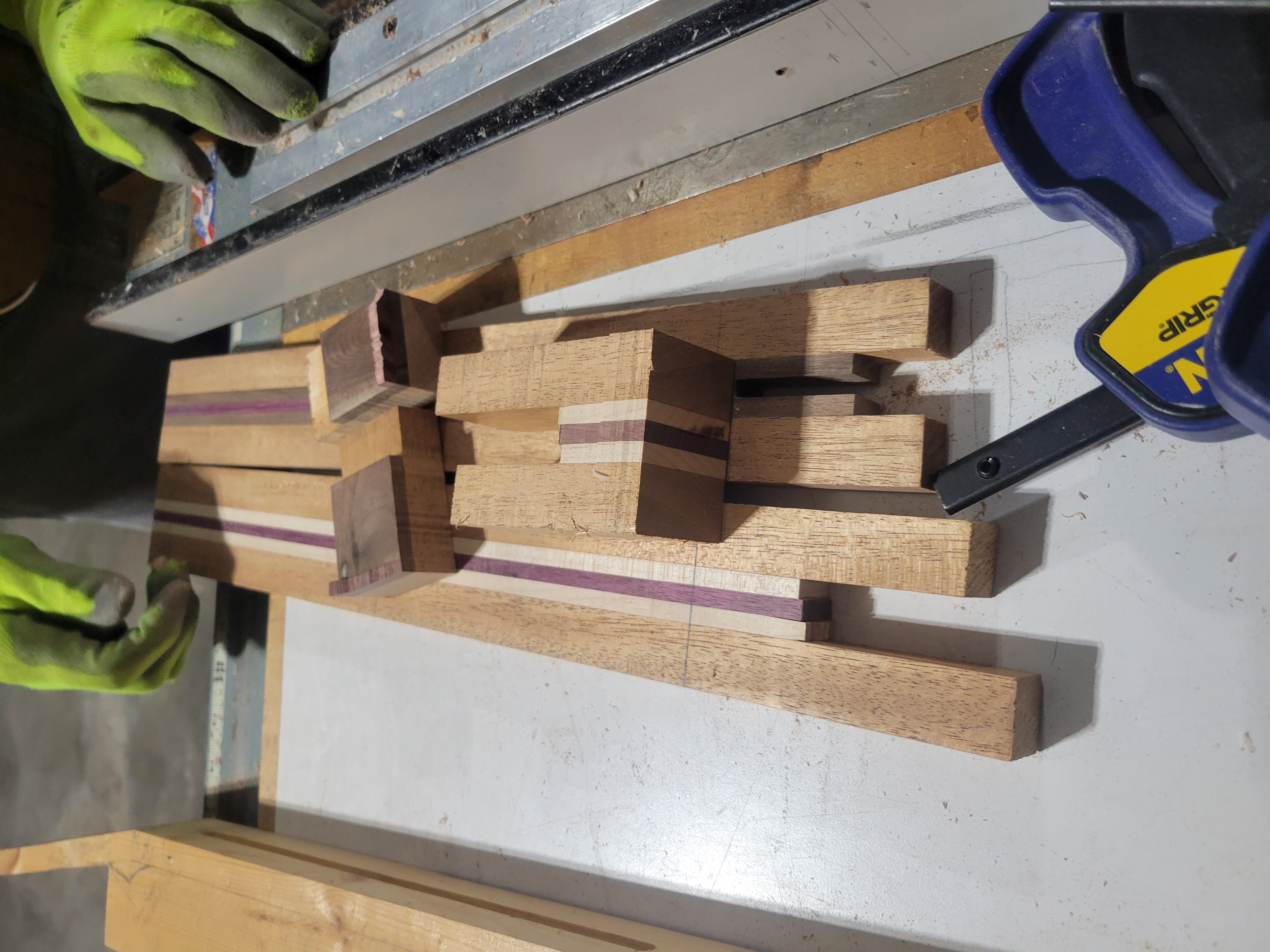 Luthier laminating wood for a handcrafted guitar on a workbench
