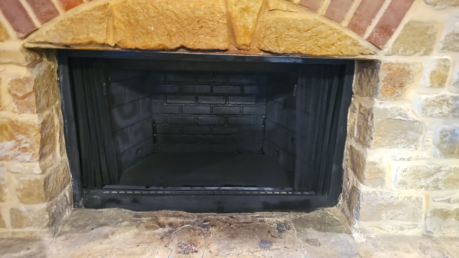 Cleaned fireplace with stone facade after restoration