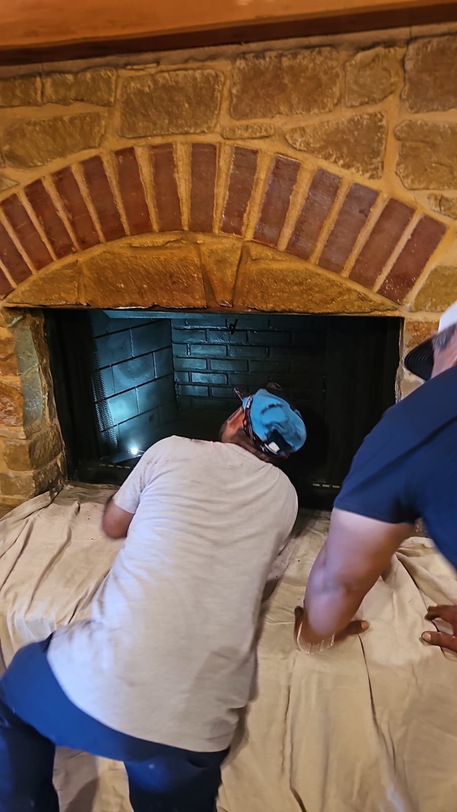Technician restoring fireplace firebox