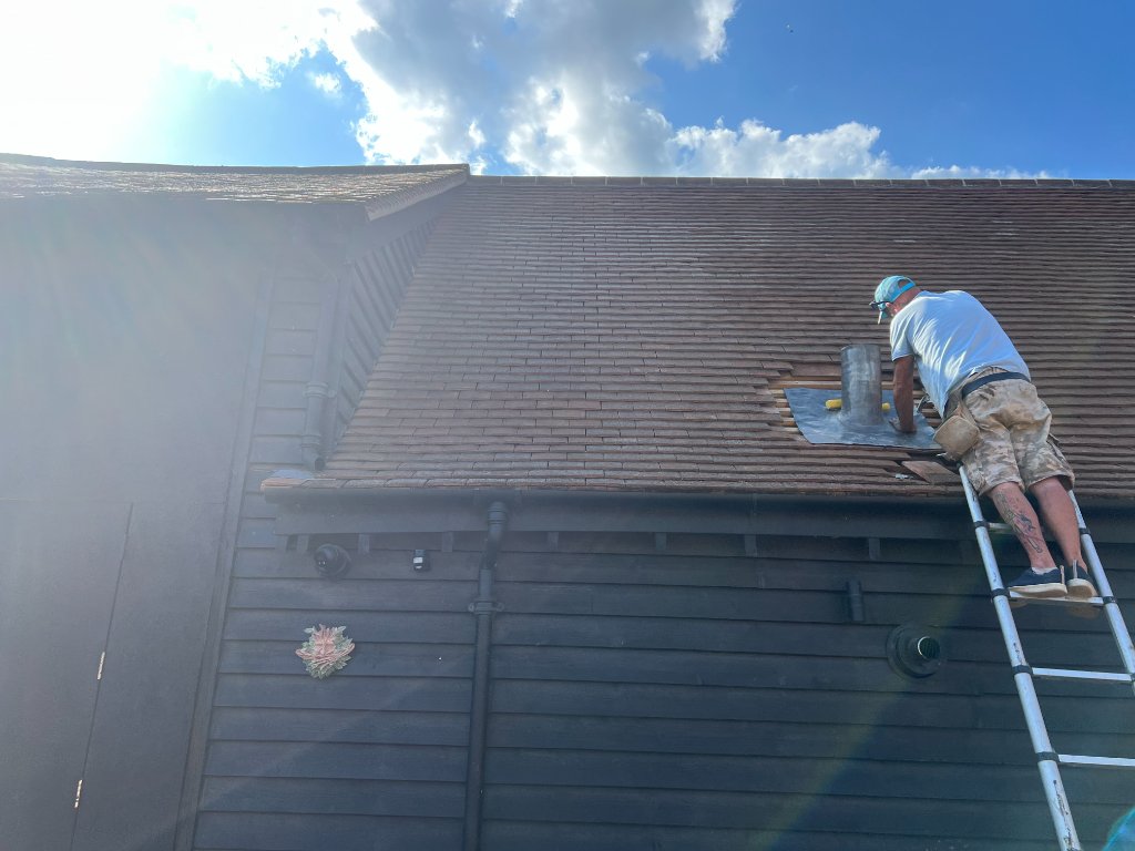 Roofer Repairing Chimney Flashing on Site