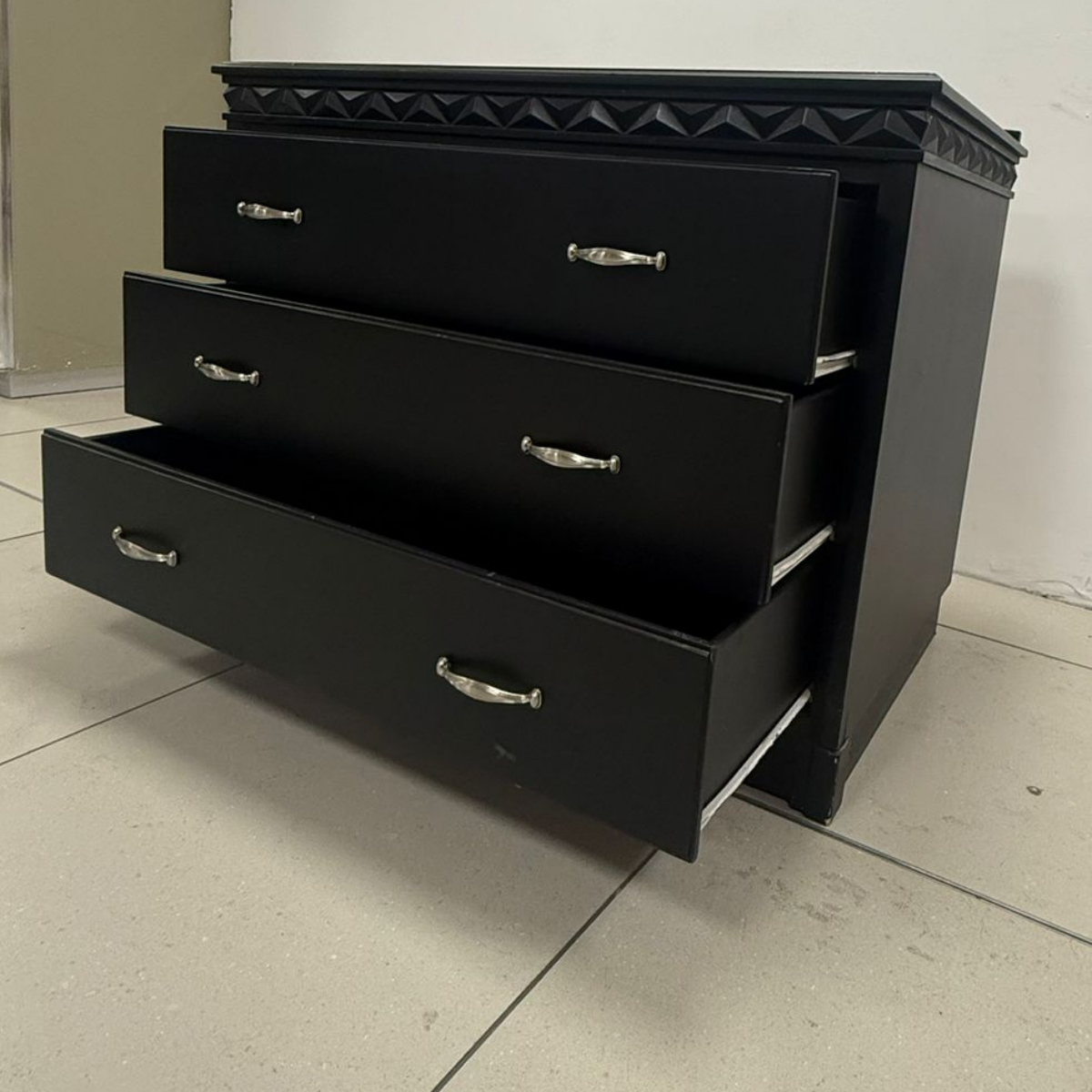 Black Three-Drawer Dresser with Carved Band