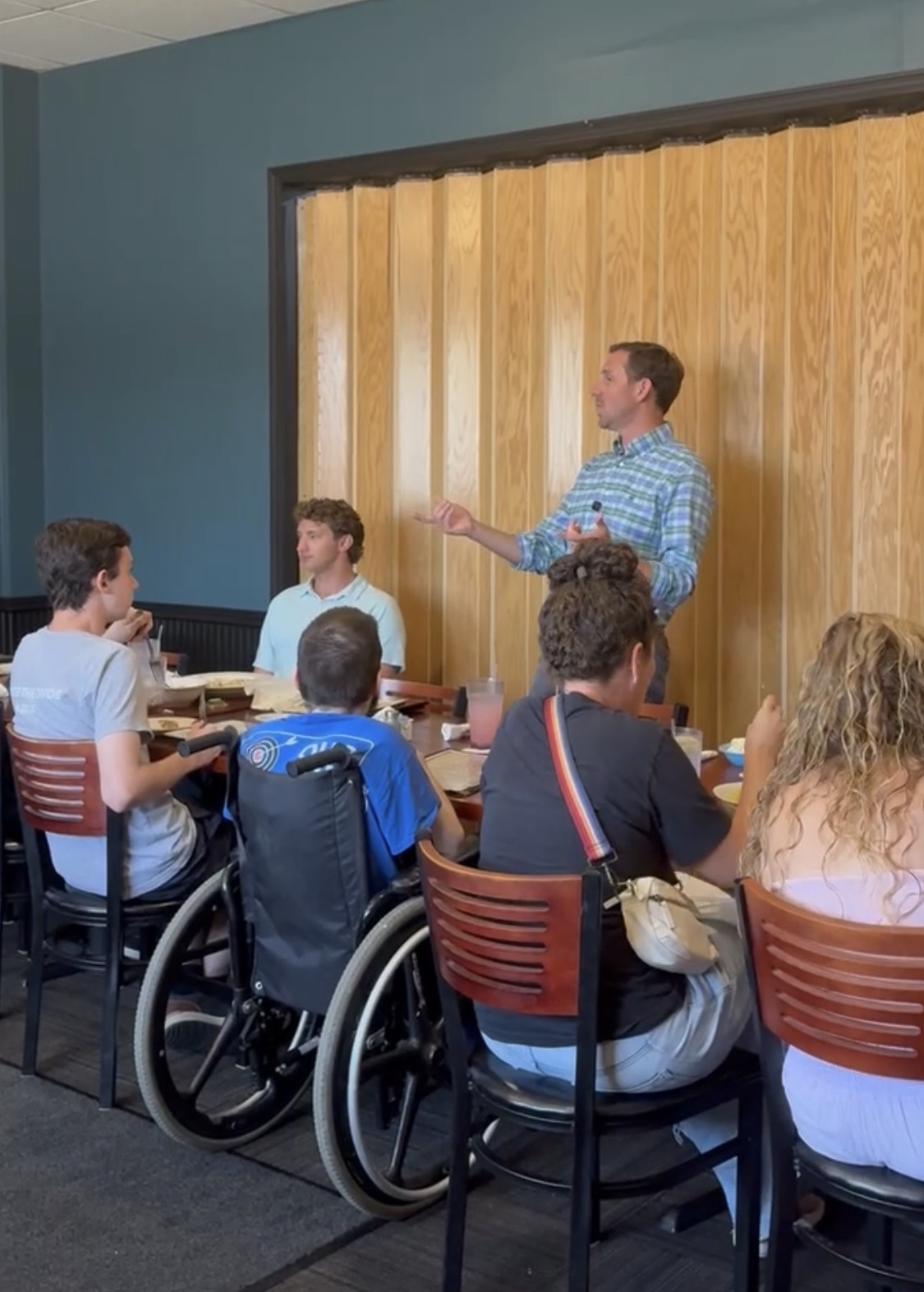 Michael Bridgford speaking to a group at an indoor dinner event