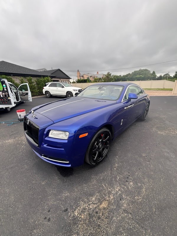 Mobile detailing on a deep metallic blue Rolls-Royce Wraith on Long Island, NY