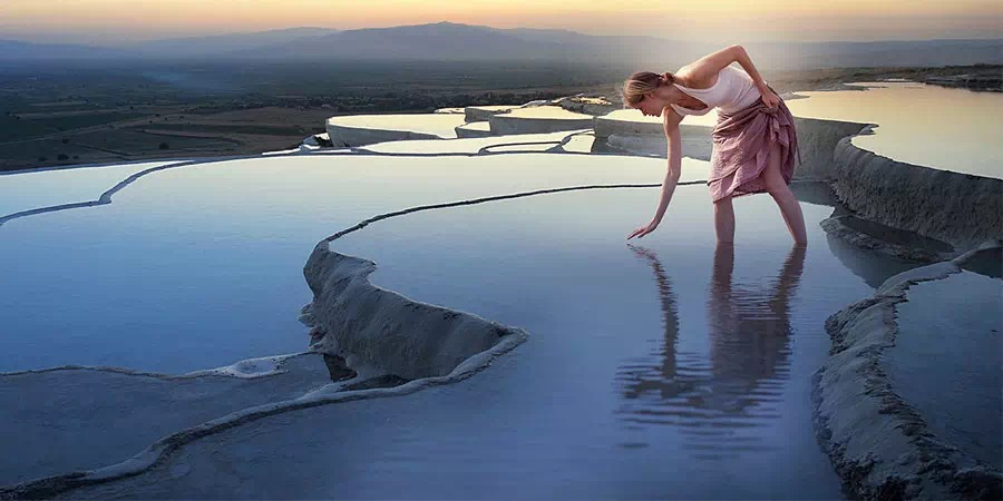 Pamukkale thermal travertine pools at sunset