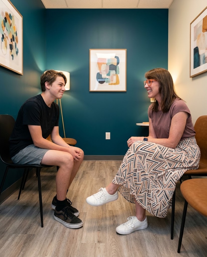 Dr. Puffer talking with a teenage patient during a relaxed, unhurried visit at Together Pediatrics in Indianapolis