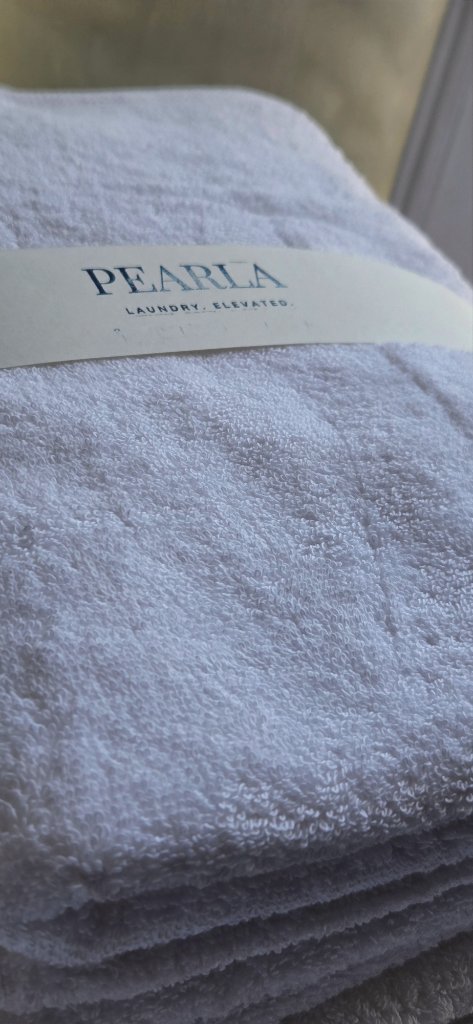 Crisp folded towel with Pearla care card
