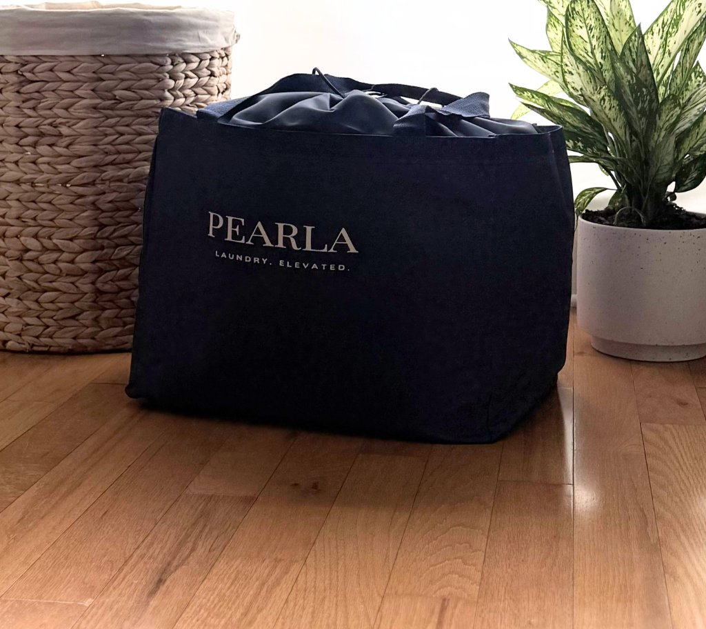 Pearla bag at home beside a woven basket
