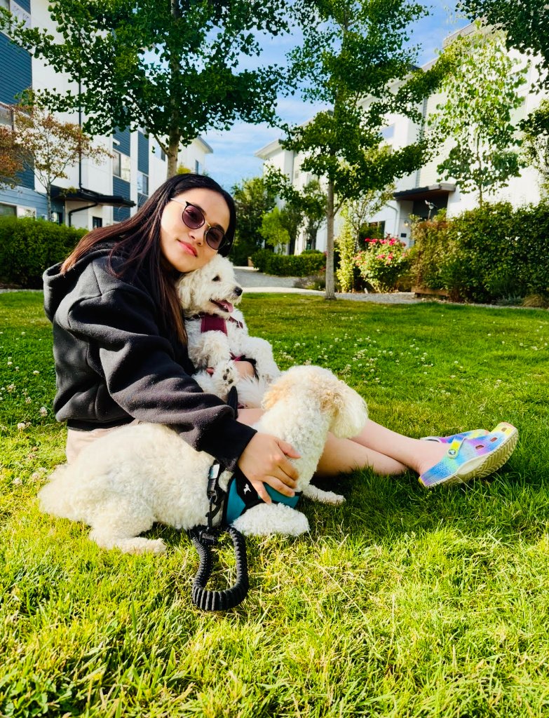 Caregiver sitting on the grass with dogs