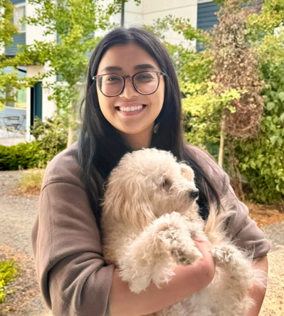 Caregiver holding a fluffy white dog