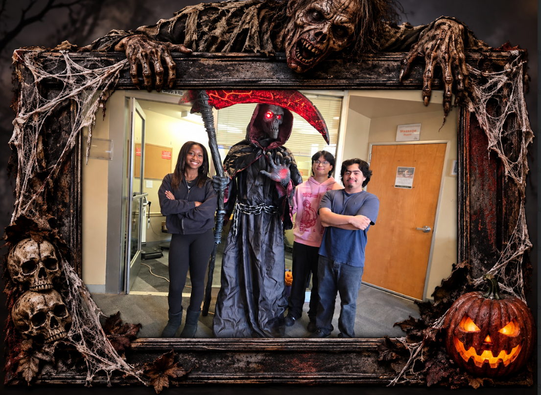 Alameda Fitness & Spa staff posing with the life-sized grim reaper prop in the club hallway for Halloween