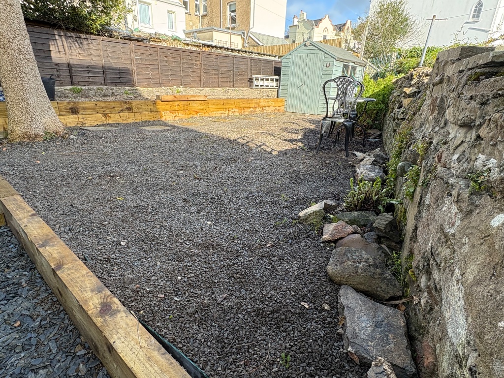 The garden — gravel terrace with railway sleeper borders