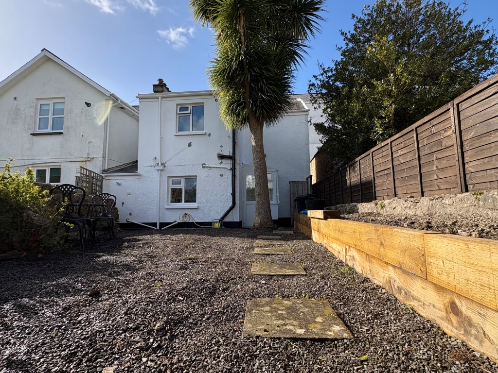 Rear garden and cottage exterior