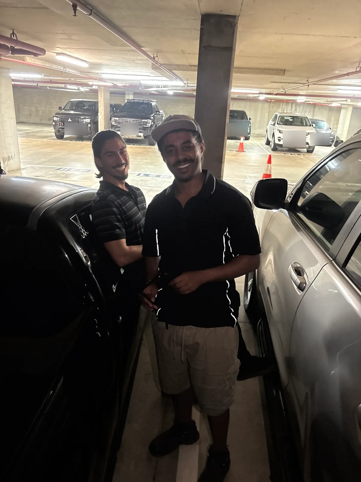 LockOps technician and a smiling driver between cars in an underground car park