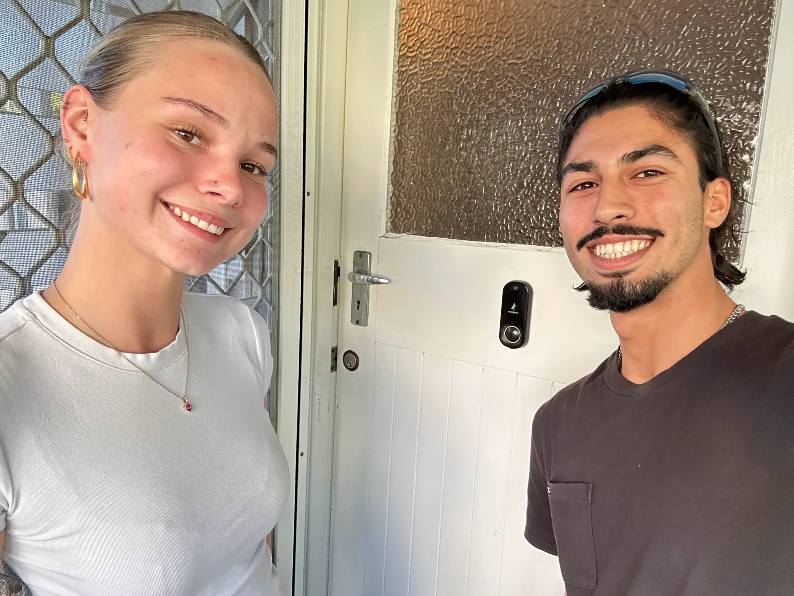 Smiling LockOps customer with the technician at her front door after the job