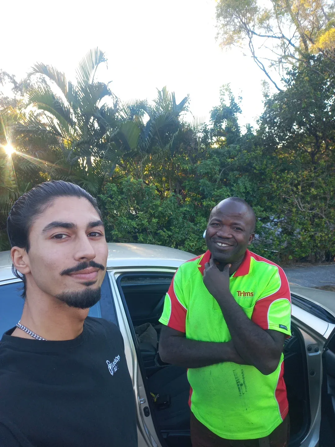 LockOps technician and a happy driver beside his car after a car lockout