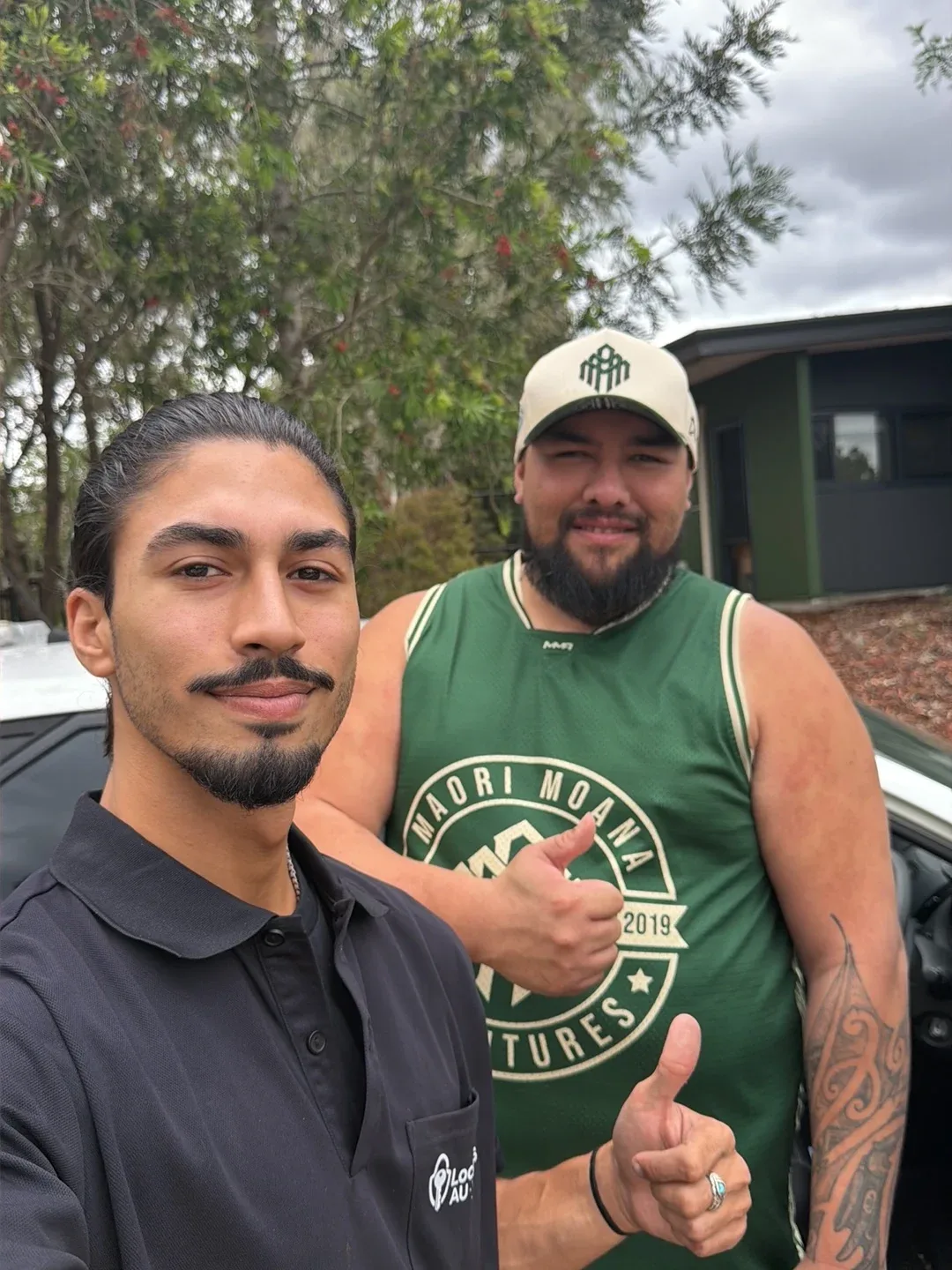 Driver giving a thumbs up with the LockOps technician next to his car