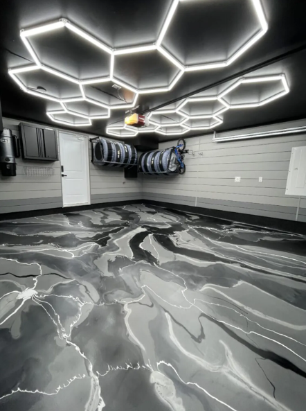 Black and grey metallic epoxy floor in a finished garage