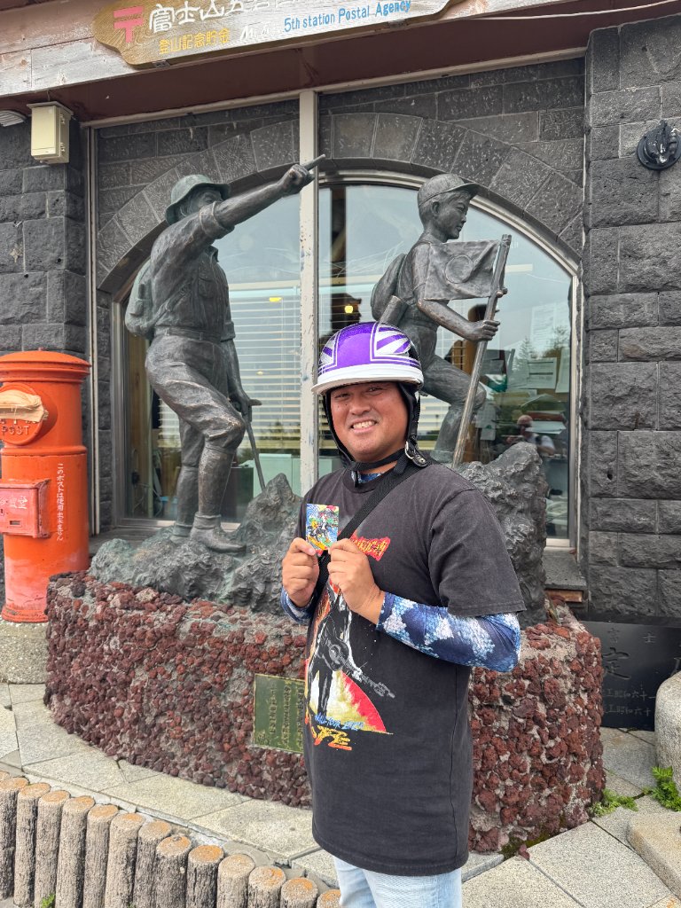 Man holding a duck card at the Mt. Fuji 5th Station Postal Agency